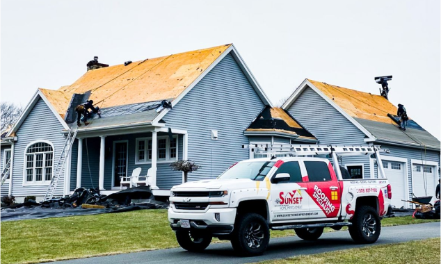 Sunset Roofing Company's truck parked at a job site, showcasing our team hard at work on your roofing project.